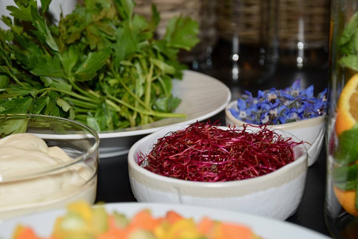 Bowls of fresh herbs, red microgreens and edible cornflowers: regional, seasonal produce from Zürich