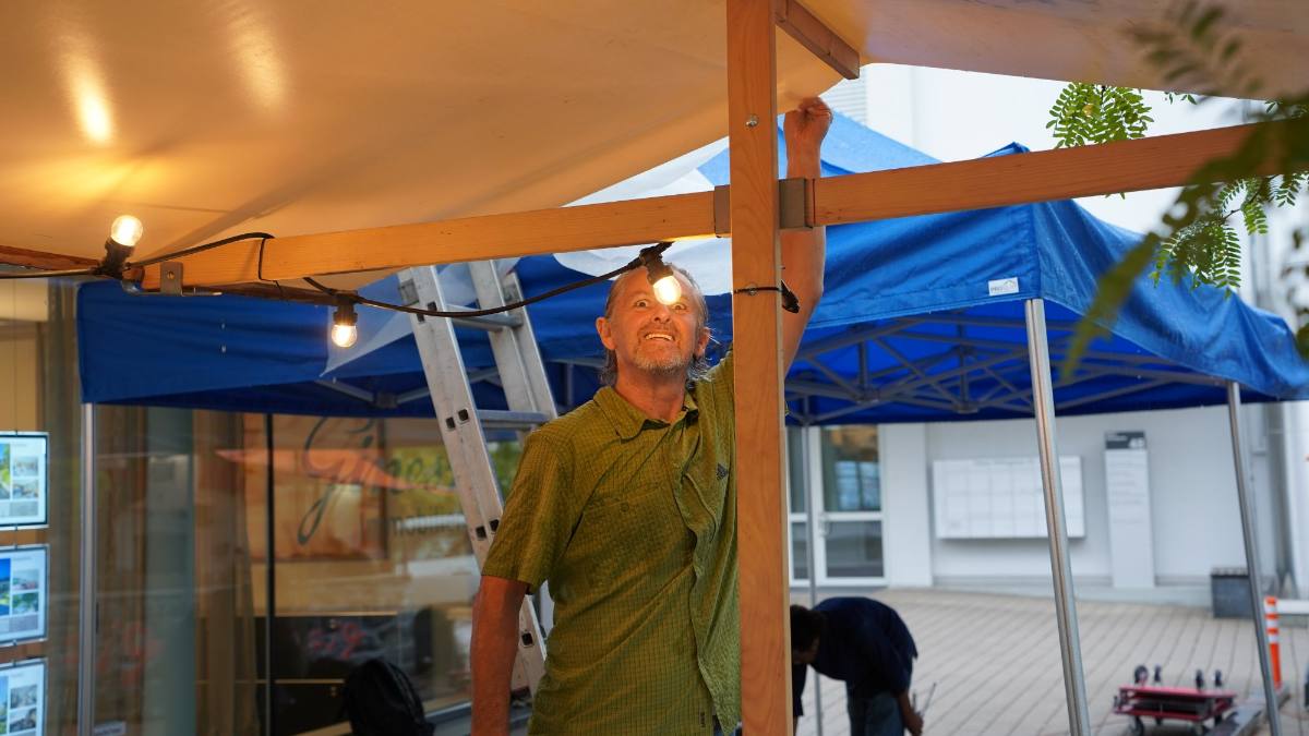 Setting up before the event: marquee, timber frame and string lights going up, event production in Zürich