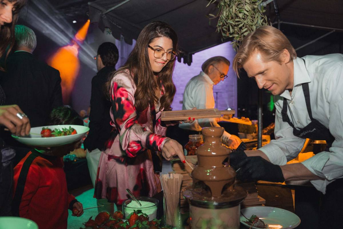 Schokoladenbrunnen als Dessertstation: Ein Koch taucht Früchte ein, private Party in Zürich
